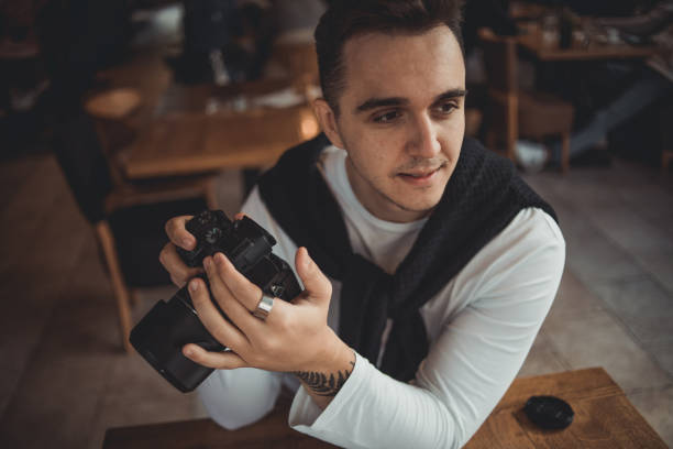 istock A man taking pictures with a camera in a cafe 1432618807