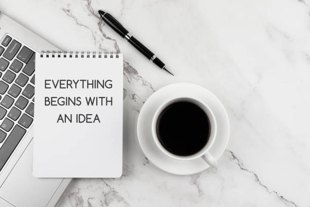 istock Cup of coffee and note pad with text Everything begins with an idea 1432620509