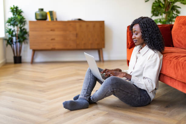 istock Young Black woman working with laptop from home 1432621879