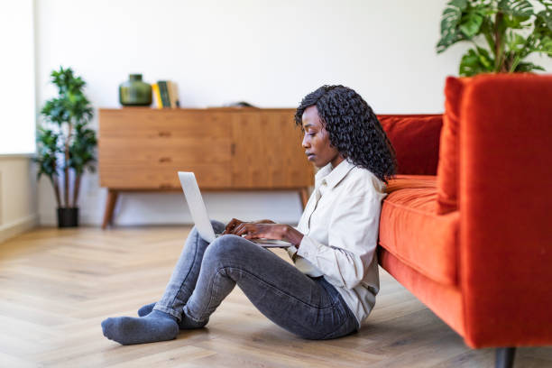 istock Young Black woman working with laptop from home 1432621887