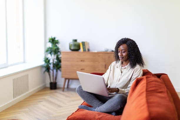 istock Young Black woman working with laptop from home 1432621958