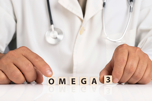 Doctor and cubes with text OMEGA 3