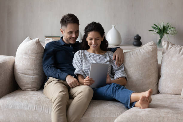 istock Millennial husband and wife using online application on tablet 1432628753