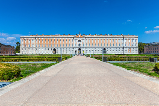 Caserta, Italy. October 29, 2017: The Royal Palace of Caserta (Italian: Reggia di Caserta). Former royal residence in Caserta, southern Italy, constructed for the Bourbon kings of Naples. Some tourists visiting.