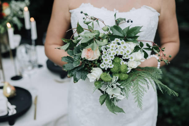 istock Young beautiful bride holding bouquet in boho style 1432633974