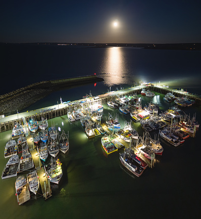 Aerial drone view of a Nova Scotian fishing town (Digby) wharf at night.