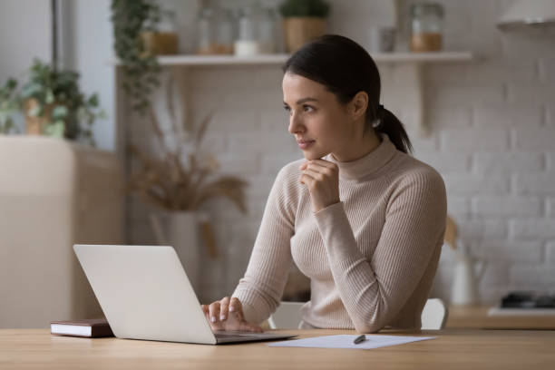 istock Pensive freelance worker working at laptop on kitchen table 1432634274