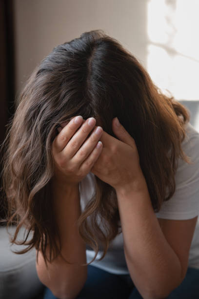 istock woman sitting upset on the couch 1432636100