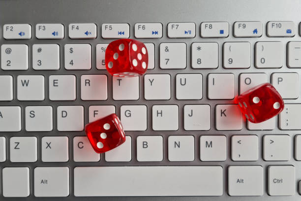istock Red dice are scattered across keyboard closeup 1432637430