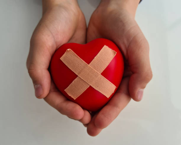 istock Wounded heart with plaster in children hands 1432637531