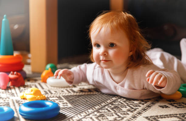 istock Red hair baby on the floor 1432638042