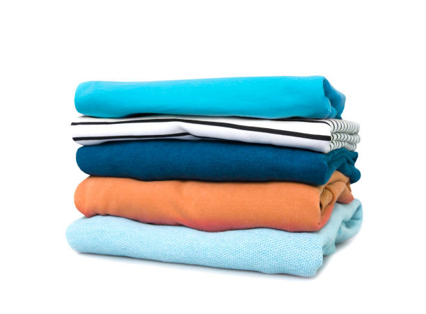 istock Stack of colorful clothes isolated. Pile of clothing on table empty space background. 1432642652