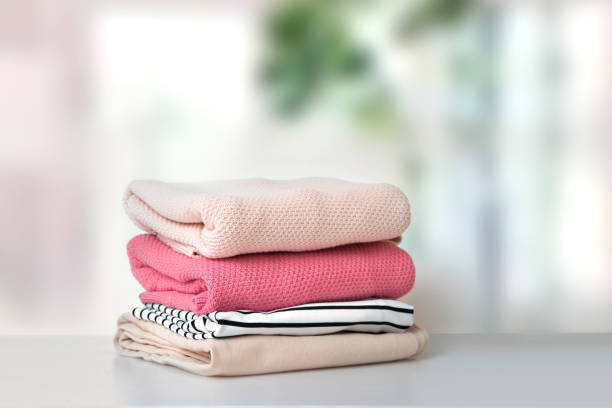 istock Soft pink stacked knitted clothing.Stack of clothes.Laundry. 1432642665