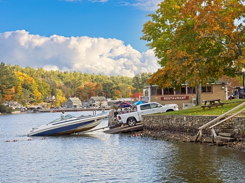 The village of Alton Bay on the south end of Lake Winnipesaukee, October 2022. Winnipesaukee, the largest lake in New Hampshire lays at the foot hills south of the White Mountains. The narrow bay provides sheltered waters prime for boat launches and boating recreation.