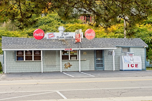 The village of Alton Bay on the south end of Lake Winnipesaukee, October 2022. Pop's is a famous eatery and in business since 1945. Winnipesaukee, the largest lake in New Hampshire lays at the foot hills south of the White Mountains. The narrow bay provides sheltered waters prime for boat launches and boating recreation.