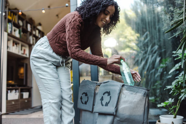istock Young woman disposes of plastic waste 1432644434