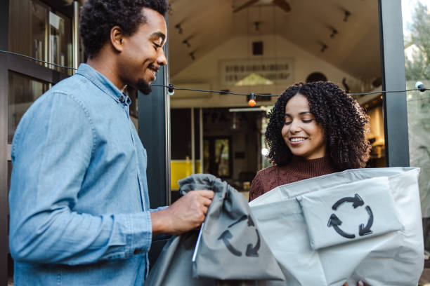 istock Young couple taking out recyclable waste from the house 1432644545