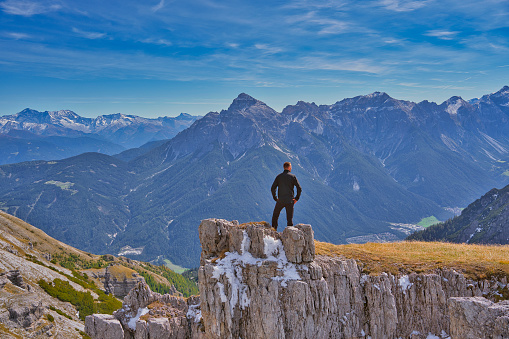 A hiker in front of the alps mountains in tyrol, Austria