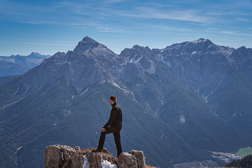 A hiker in front of the alps mountains in tyrol, Austria