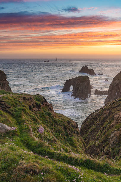istock Lands End at sunset, with Enys Dodnan Arch and Longship Lighthouses 1432651368