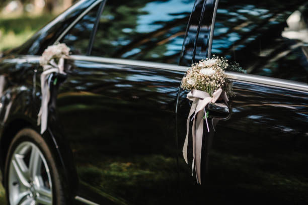 istock Flower decor on black car. Wedding car with beautiful decorations. 1432655276