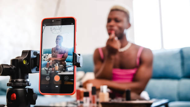 istock Transgender beauty blogger applying makeup to mobile phone camera 1432655449
