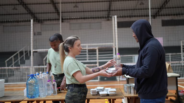 Soldiers giving donations to refugees in a sheltering