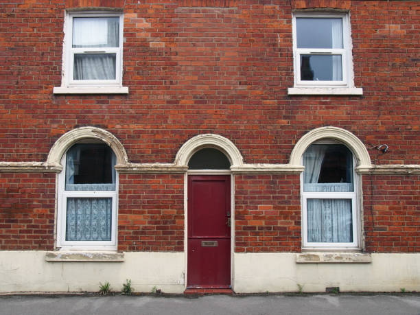 istock red front door and windows of a typical old brick british terraced house with arched windows and net curtains 1432659147