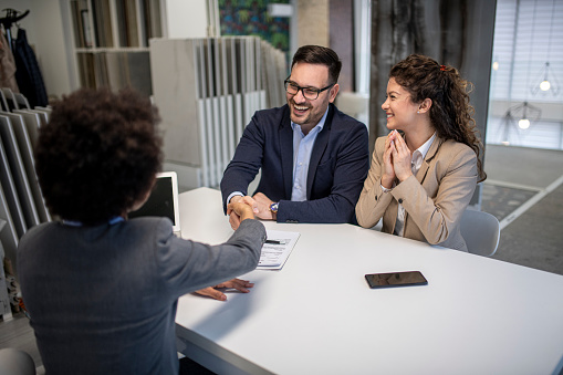 Young business couple signing a contract