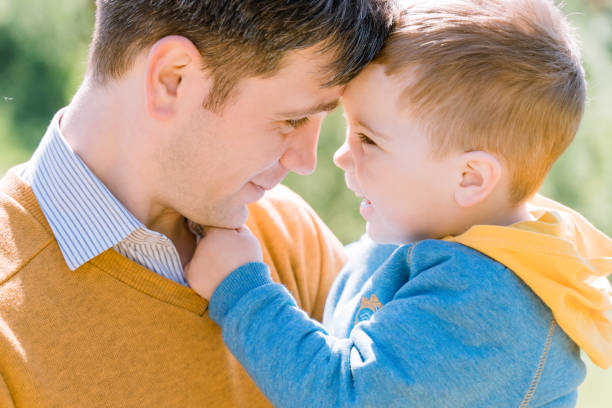 istock A young father with a three-year-old son are hugging and smiling outdoors. The concept of raising a happy child 1432663368