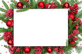 istock Traditional Christmas background with Christmas decorations in red colors. Christmas frame made of real spruce branches with festive decorations and confetti. Merry christmas design template. 1432667997