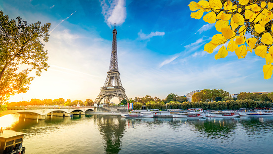 Paris Eiffel Tower and river Seine with sunrise in Paris, France. Eiffel Tower is one of the most iconic landmarks of Paris, web banner format ar early morning at fall