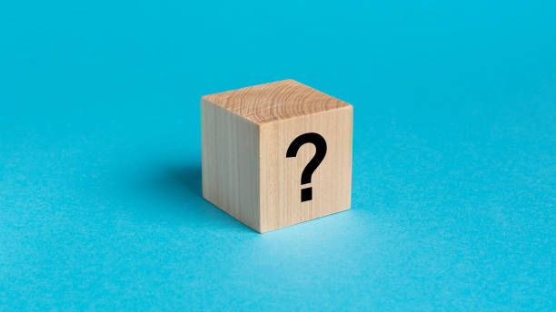 istock wooden toy cube with a question mark viewed high angle on a blue background with copy space 1432668349