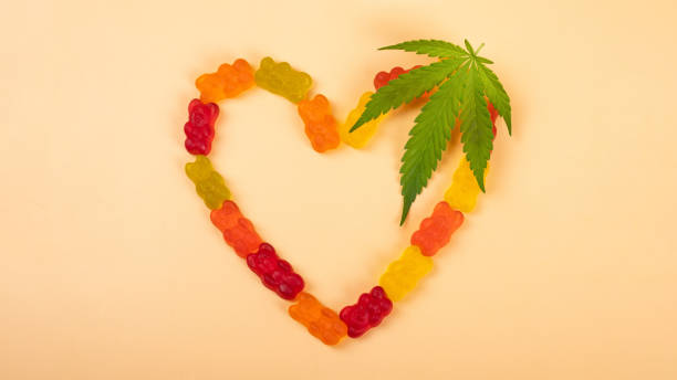cannabis jelly candie heart and green leaf, recreational drugs stock photo