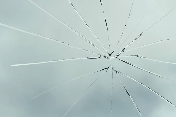 istock Crack on the glass against the sky, broken glass 1432671608