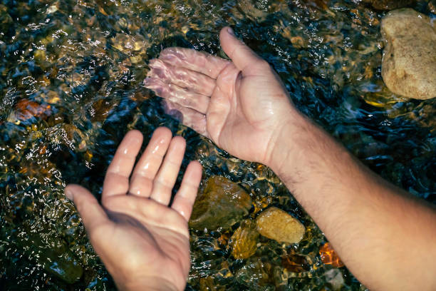 istock Man washing his hands in the river 1432672612