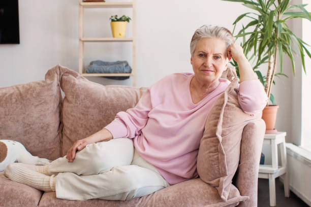 istock Smiling middle aged mature grey haired woman at home 1432676754