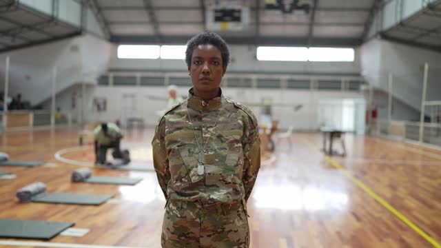 Portrait of a female soldier at a sheltering gymnasium