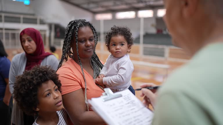 Volunteer talking to family during control in a sheltering