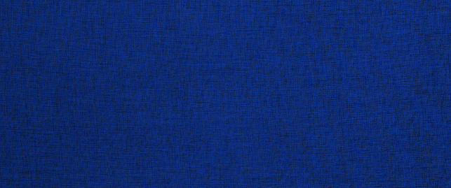 Dark blue fabric texture. Wide panoramic close-up texture of natural weave cloth in blue color. Fabric texture of natural cotton or linen textile material.