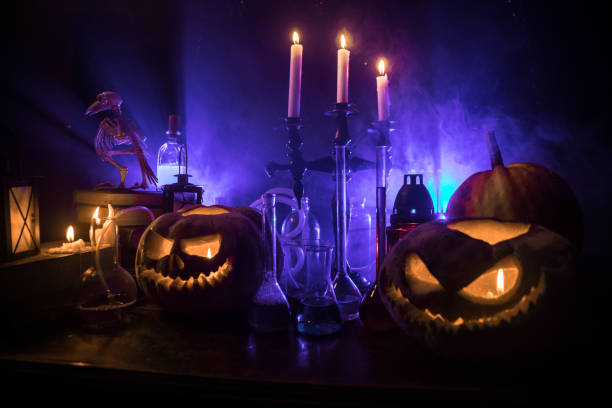 istock Halloween still-life background with different elements on dark toned foggy background. Selective focus 1432684744