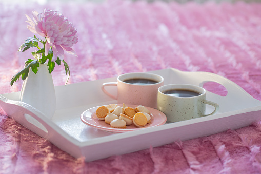 two cups of coffee on white tray in bedroom