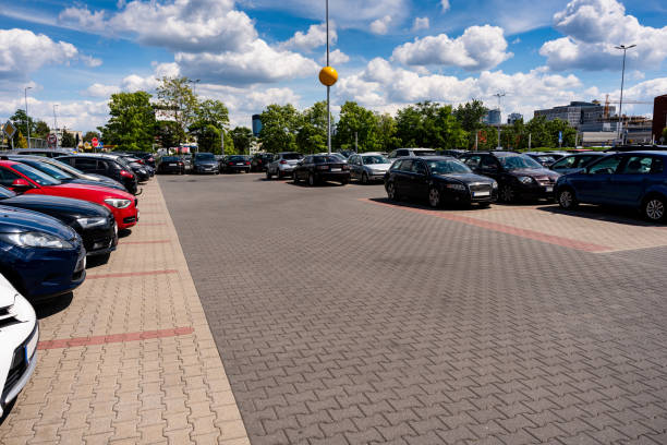 Parking lot cars. Car lot parking space in underground city garage. Empty road asphalt background. Industrial Shed or Parking Lot. Parking lot cars. Car lot parking space in underground city garage. Empty road asphalt background. Industrial Shed or Parking Lot empty dealership interior stock pictures, royalty-free photos & images