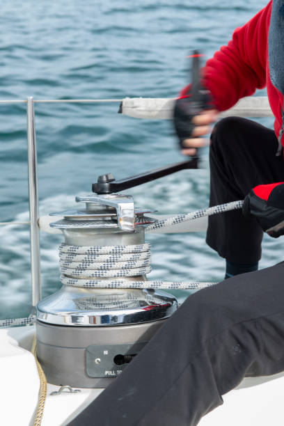 istock Sailor winding rope on winch with hands 1432687469