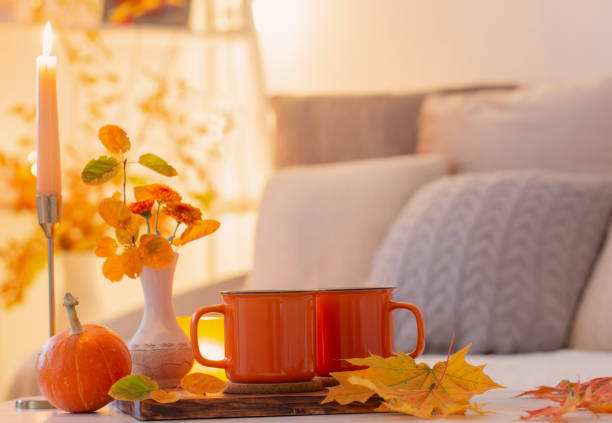 istock two orange cups with hot drink in autumnal light interior 1432689047