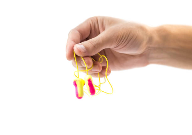 istock The hand holds bright earplugs on a white background 1432689862