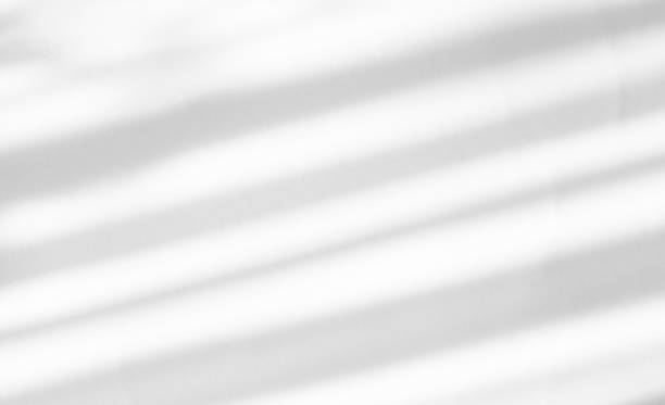 istock An abstract shadow from the blinds falling from the window on a light background. Copy space. The perfect backdrop for your presentation 1432692173
