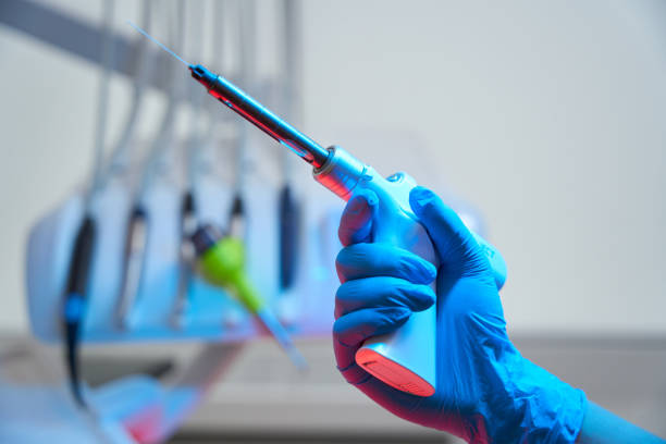 istock Hand of dentist holds device for three-dimensional obturation of canals 1432692399