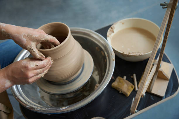 istock Potter hands in the process of working with clay product 1432692651