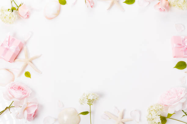 istock Elegant gift box and beautiful pink rose flowers on white background, flat lay. Space for text. 1432694537